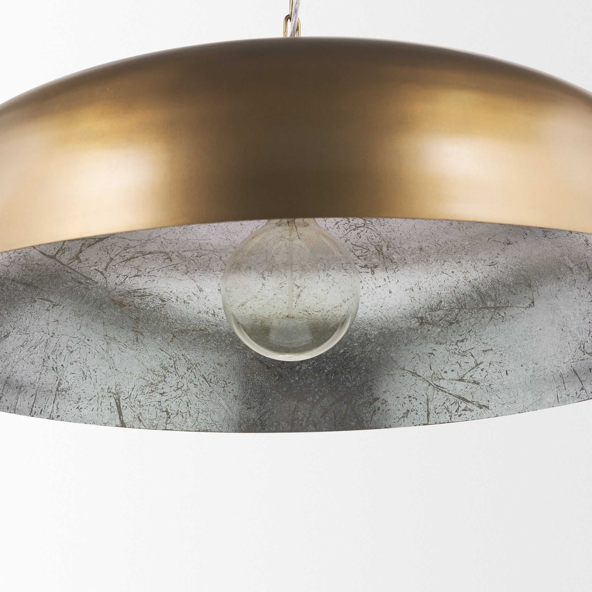 Sanne Antiqued Gold Metal w/ Silver Foil Wide Pendant Light shown from a different angle to reveal its silhouette.