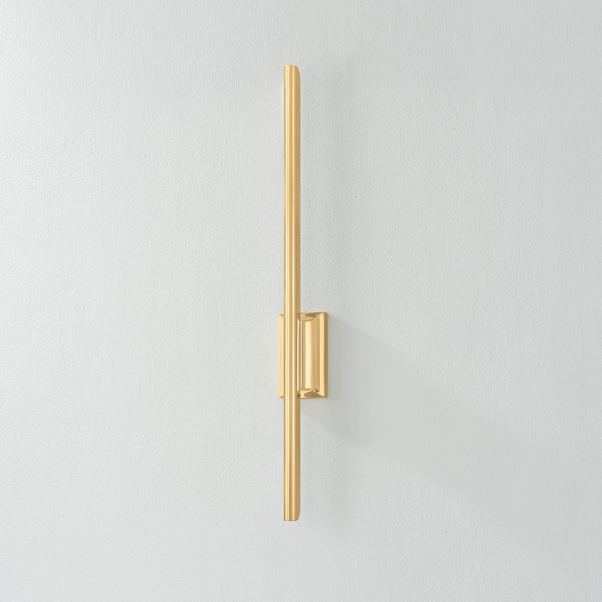 Bernard Wall Sconce in aged brass shown from the front to reveal the arm curve and shade silhouette.