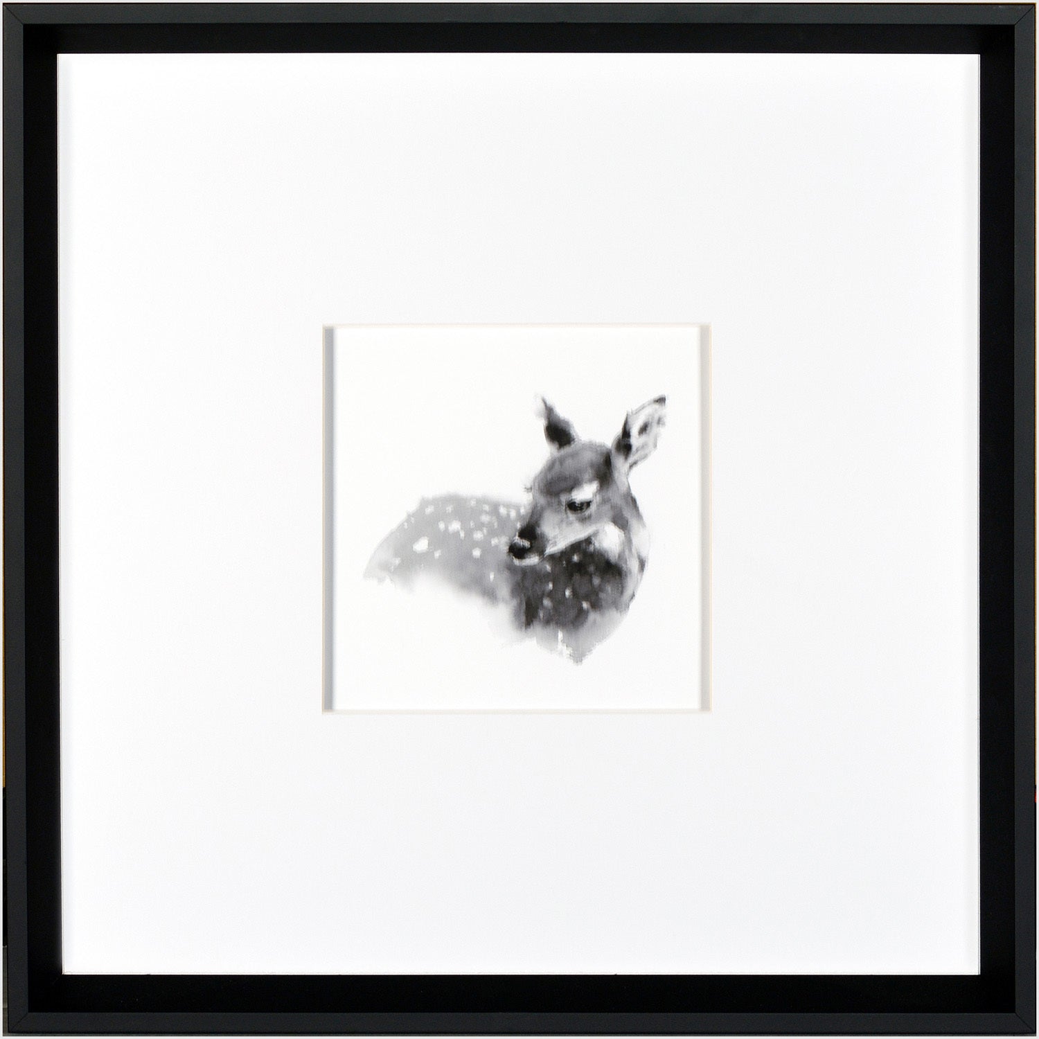 Fawn wall art featuring a black and white illustration of a deer in a black frame