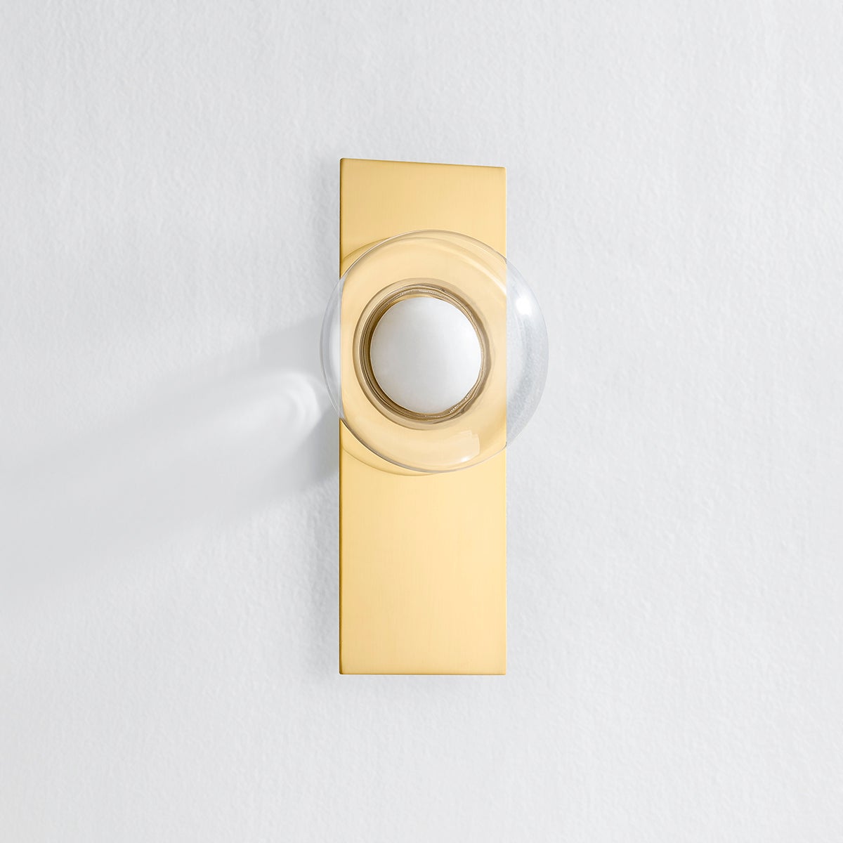 Pound Ridge Wall Sconce in aged brass shown from the front to reveal the arm curve and shade silhouette.