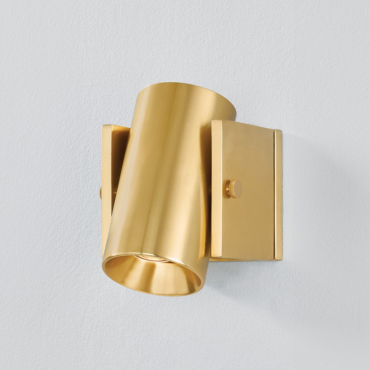 Close-up of the Nowra Wall Sconce in Aged Brass showing the arm curve and shade silhouette.