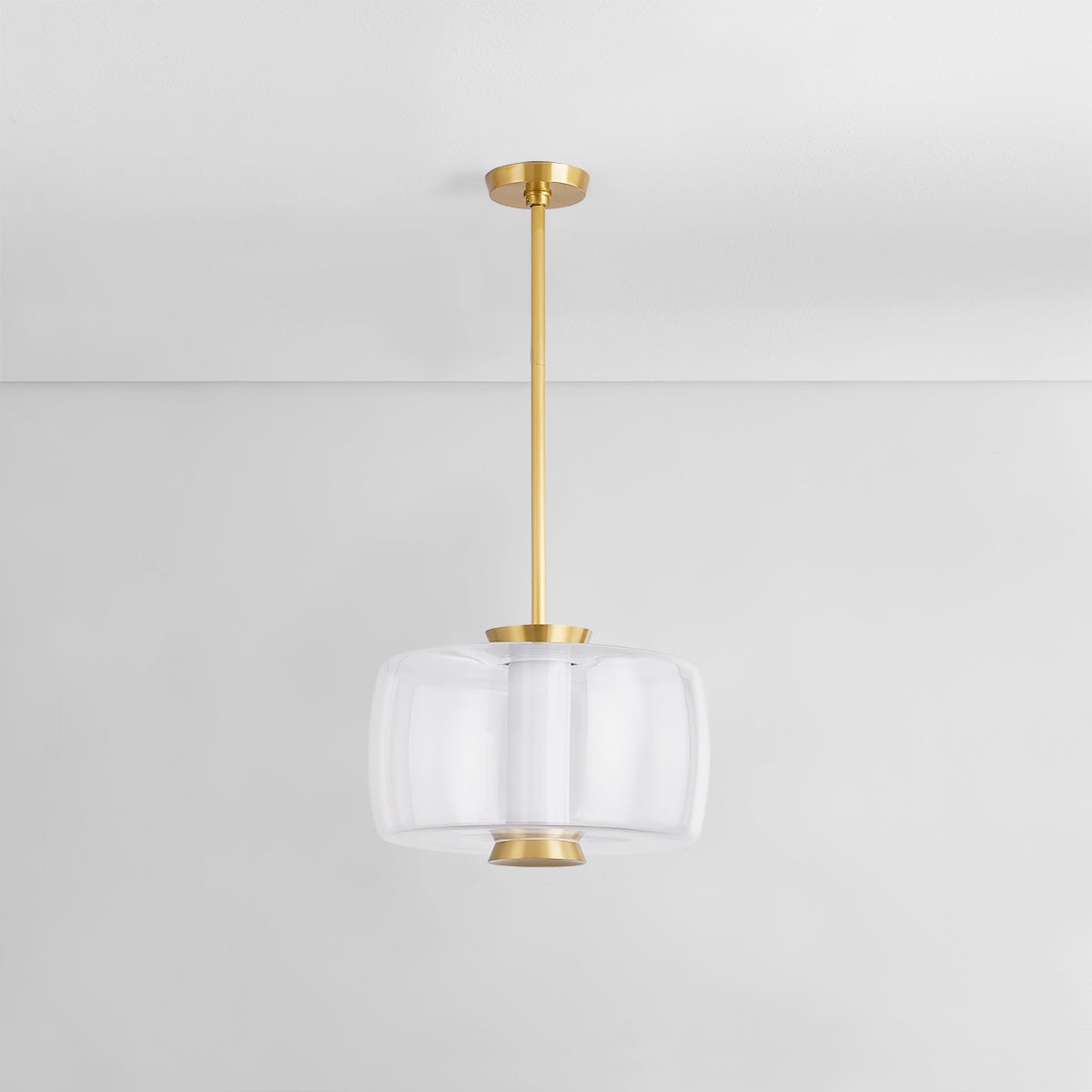 Beau Pendant 15" in aged brass shown from the front to reveal the shade shape and metal detail.