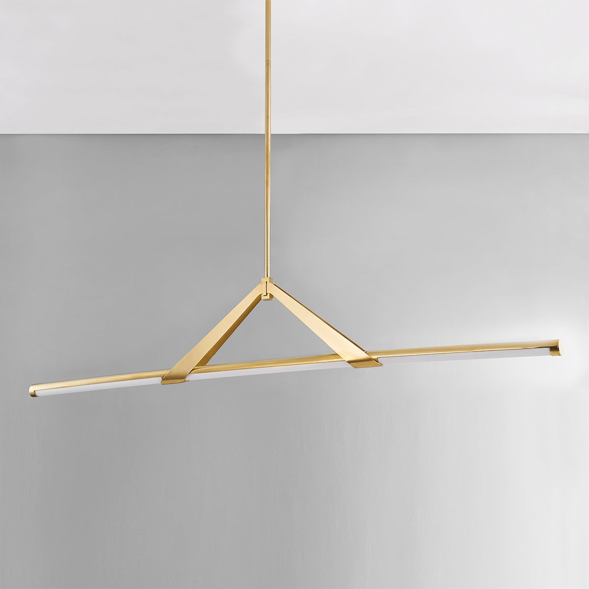 Jonas Linear in aged brass shown from the front to reveal the extended frame and shade array.
