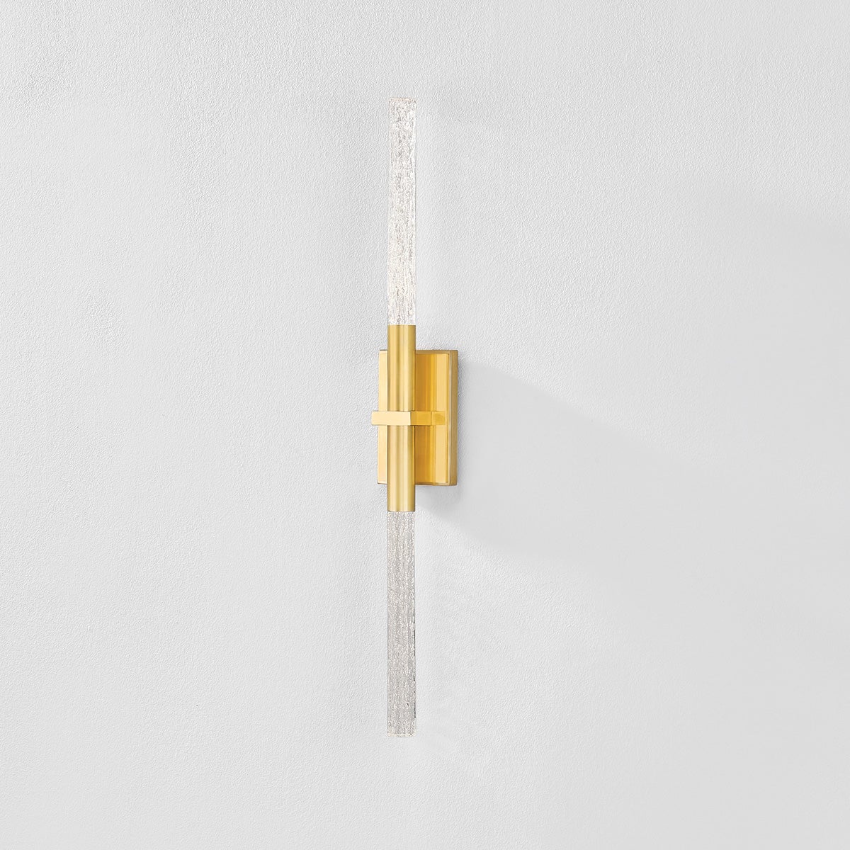 Close-up of the Millerton Wall Sconce in aged brass showing the arm curve and shade silhouette.