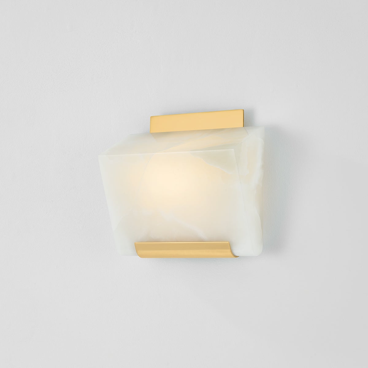 Close-up of the Fairfield Wall Sconce in aged brass showing the arm curve and shade silhouette.