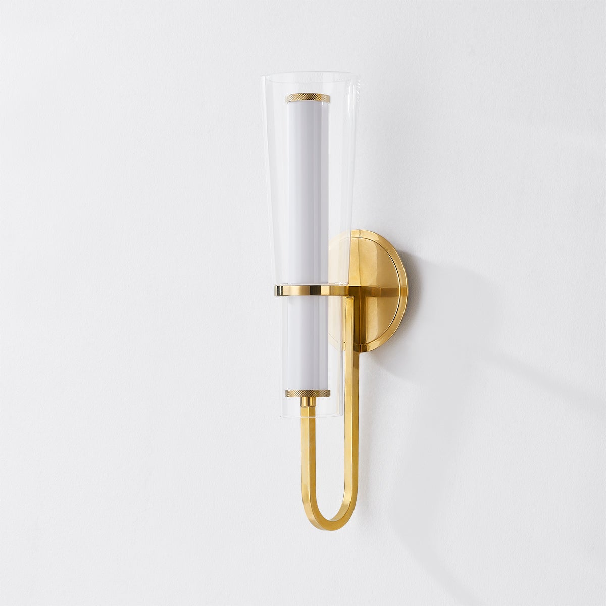 Vancouver Wall Sconce in aged brass shown from the front to reveal the arm curve and shade silhouette.