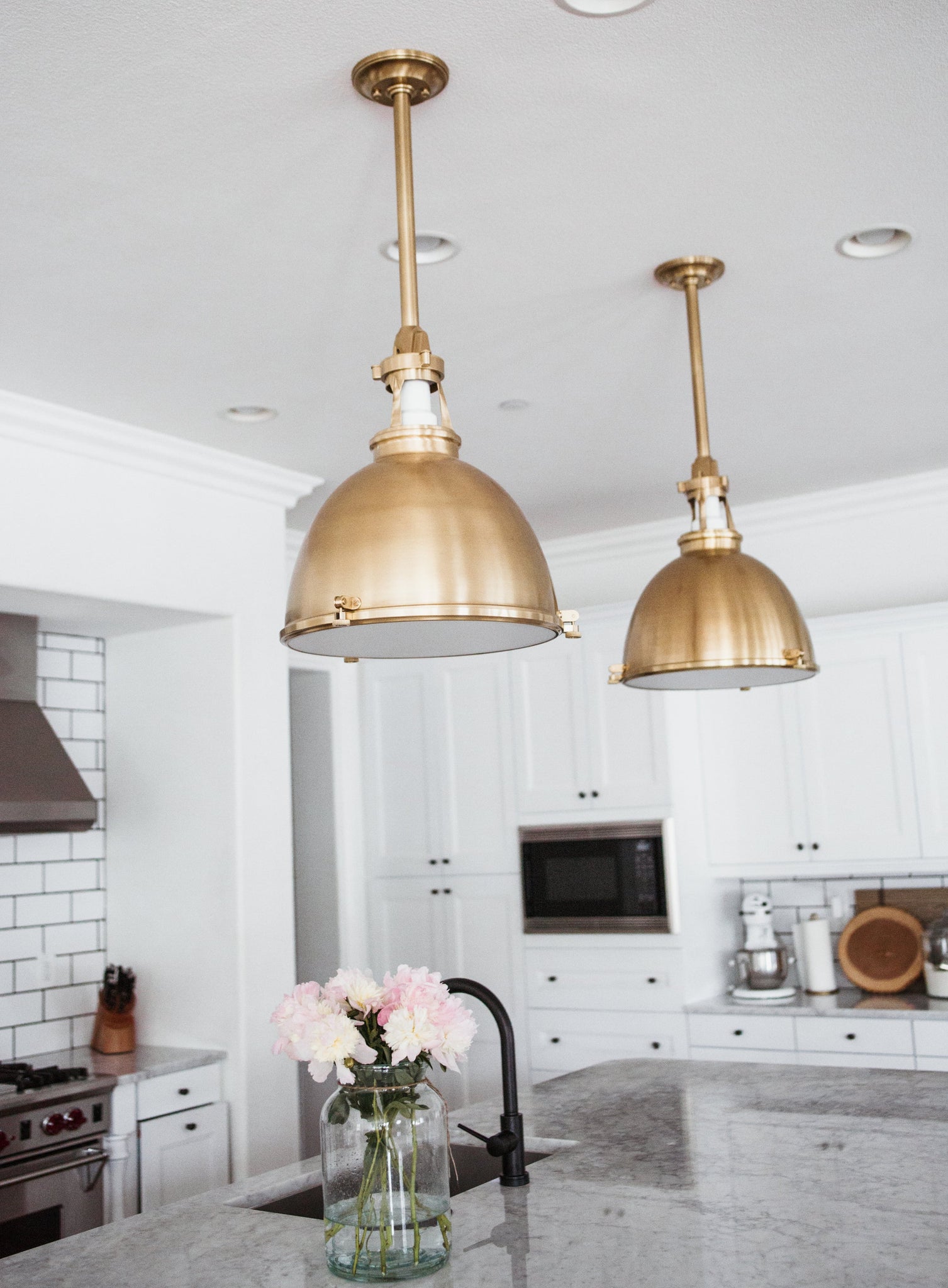 Close-up of the Massena Pendant 19.5" in aged brass showing the shade shape and metal detail.