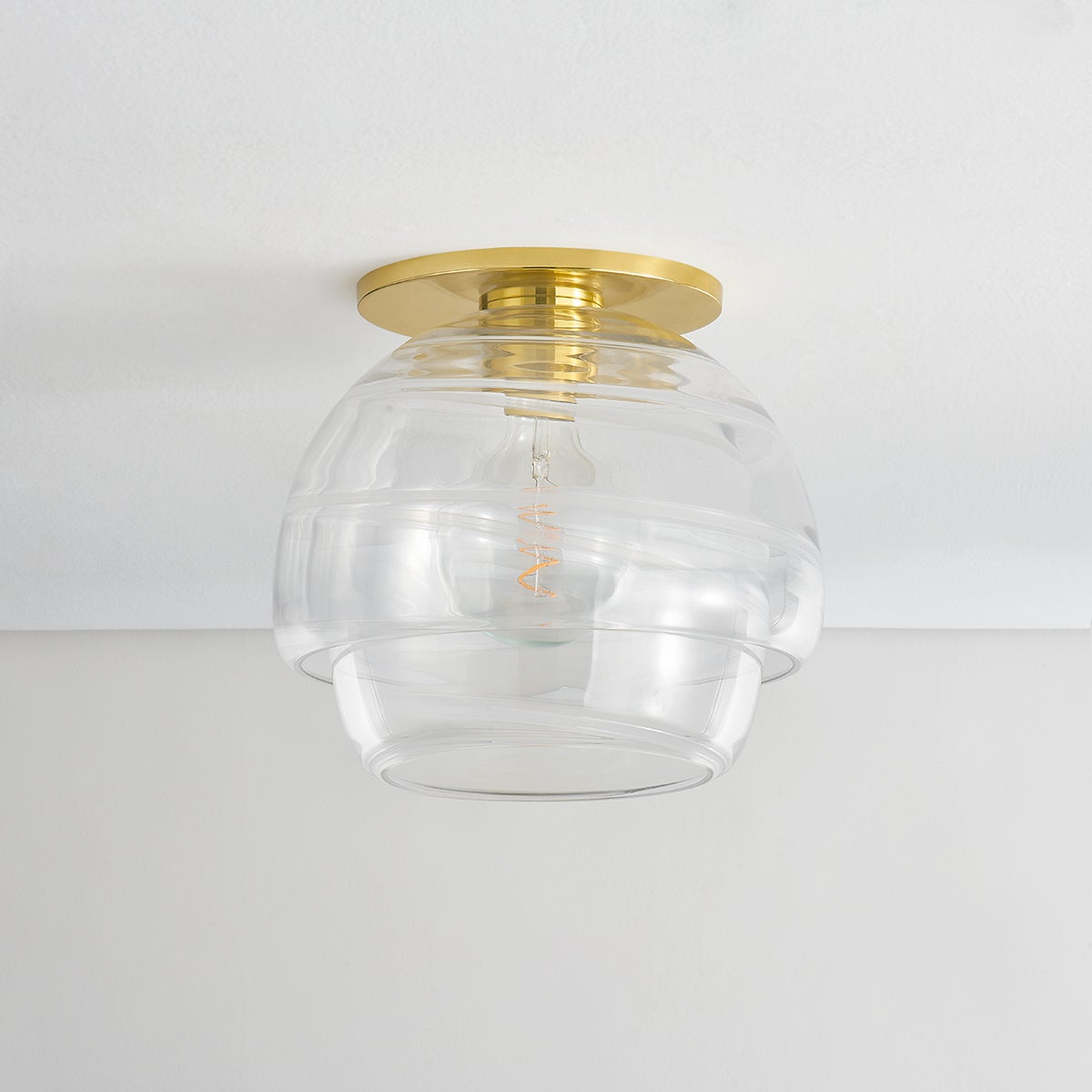 Montvale Flush Mount in aged brass shown from a second angle to highlight the shade profile and mounting canopy.