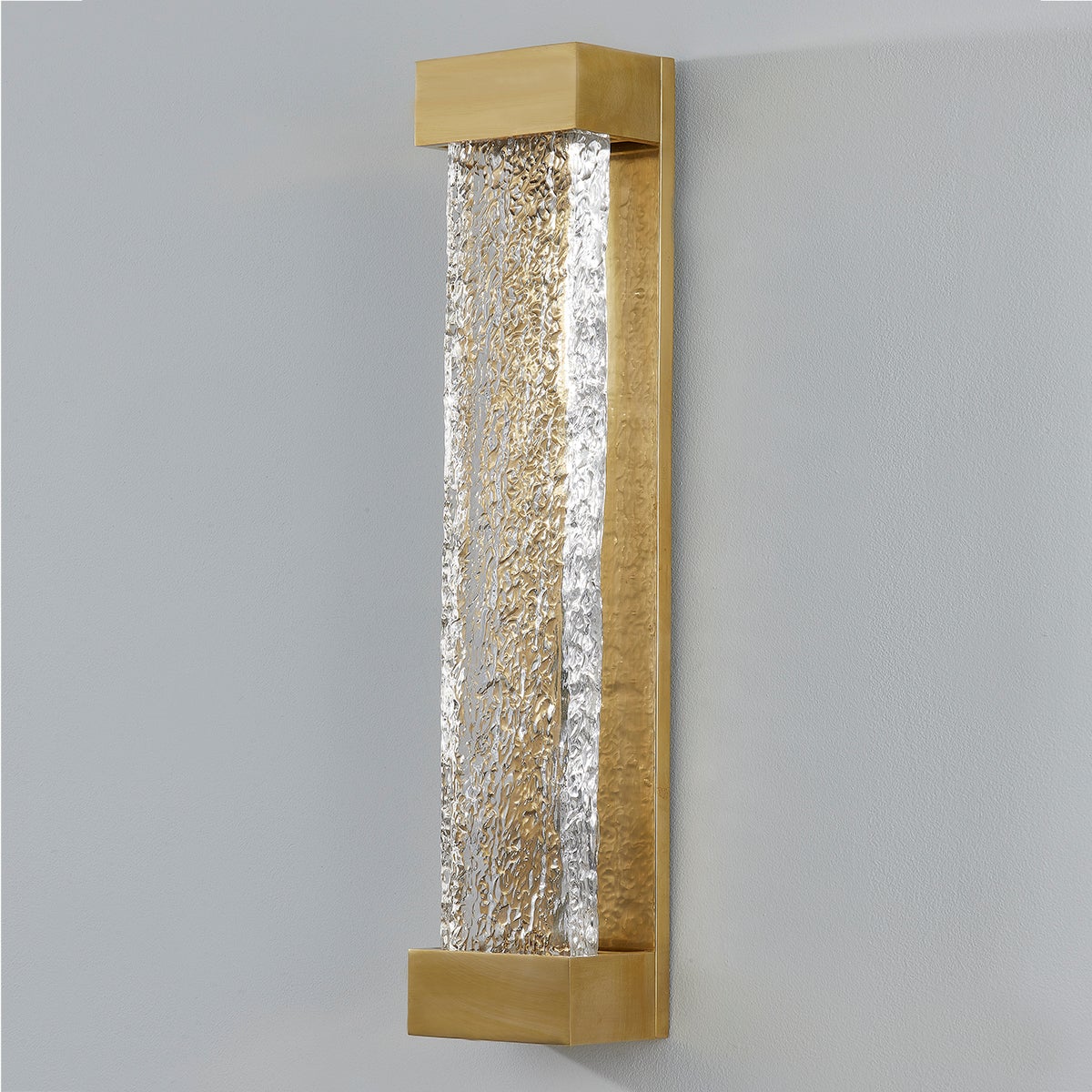 Wharton Wall Sconce 5" x 23" in aged brass shown from the front to reveal the arm curve and shade silhouette.