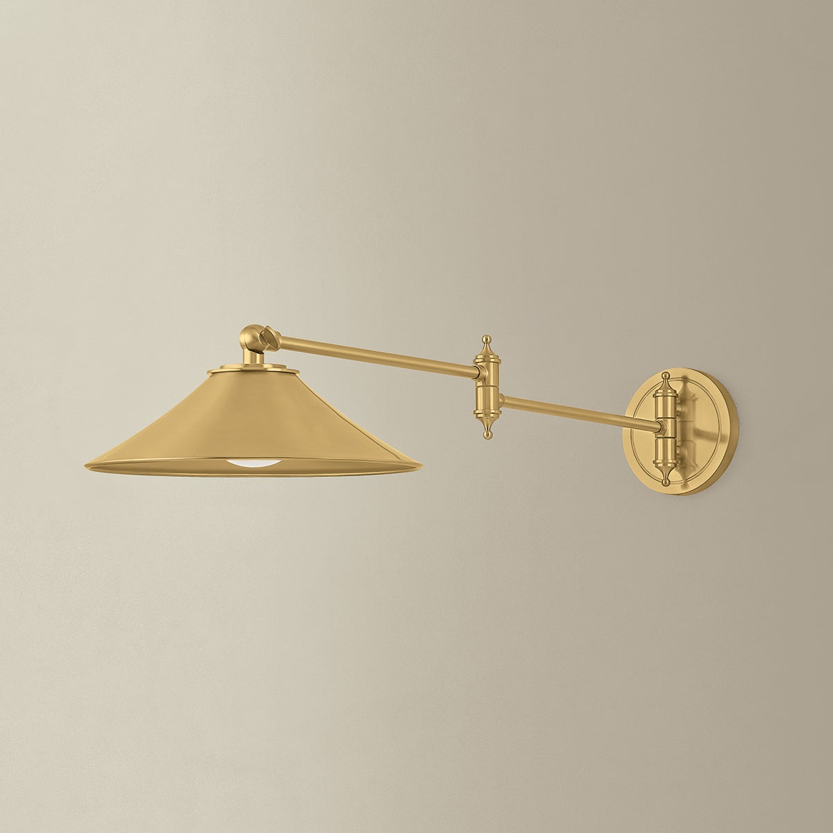 Lithgow Wall Sconce in aged brass shown from a second angle to highlight the arm curve and shade silhouette.