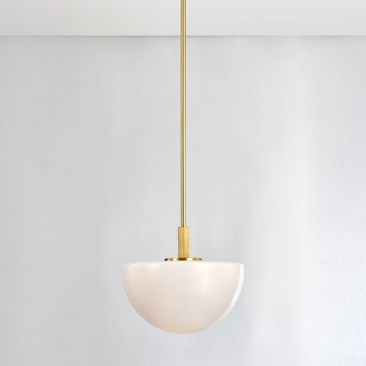 Close-up of the Lethbridge Pendant 15" in aged brass showing the shade shape and metal detail.