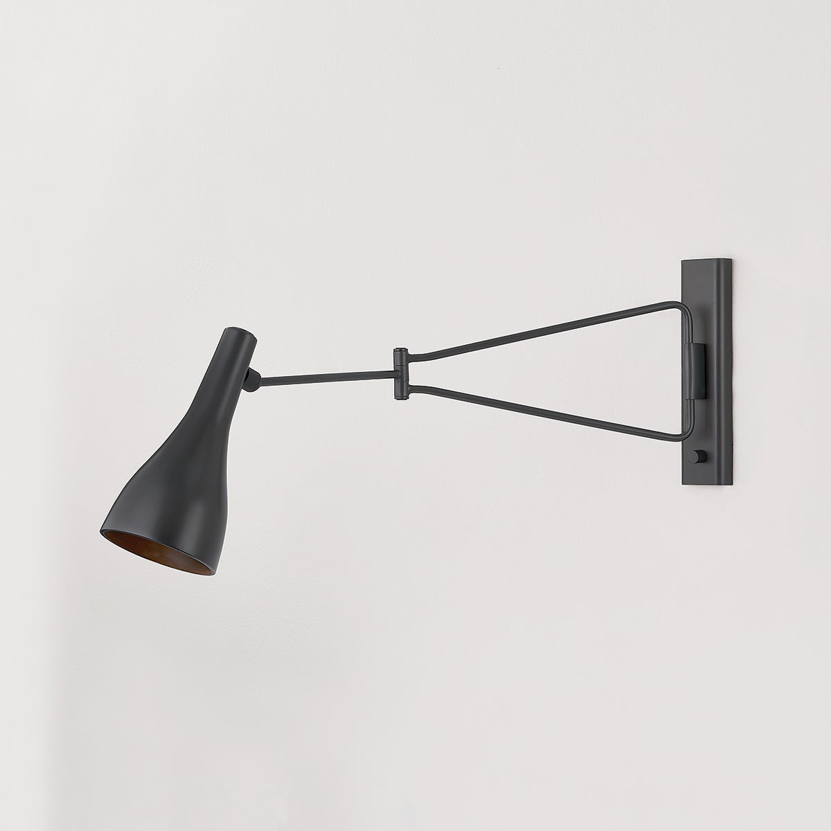 Close-up of the Northford Wall Sconce in dark bronze showing the arm curve and shade silhouette.