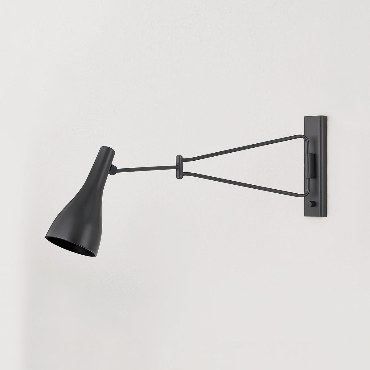 Close-up of the Northford Wall Sconce in dark bronze showing the arm curve and shade silhouette.