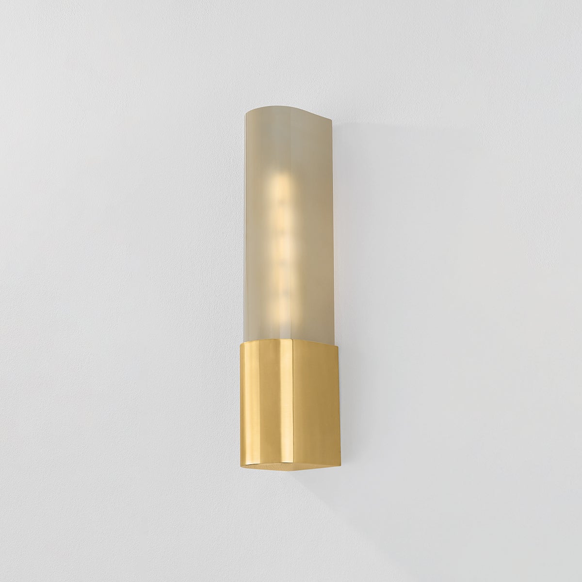 Somersville Wall Sconce 3.25" x 16" in aged brass shown from the front to reveal the arm curve and shade silhouette.