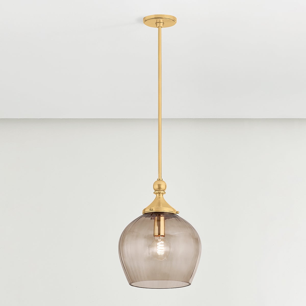 Close-up of the Chatton Pendant 12" in aged brass showing the shade shape and metal detail.