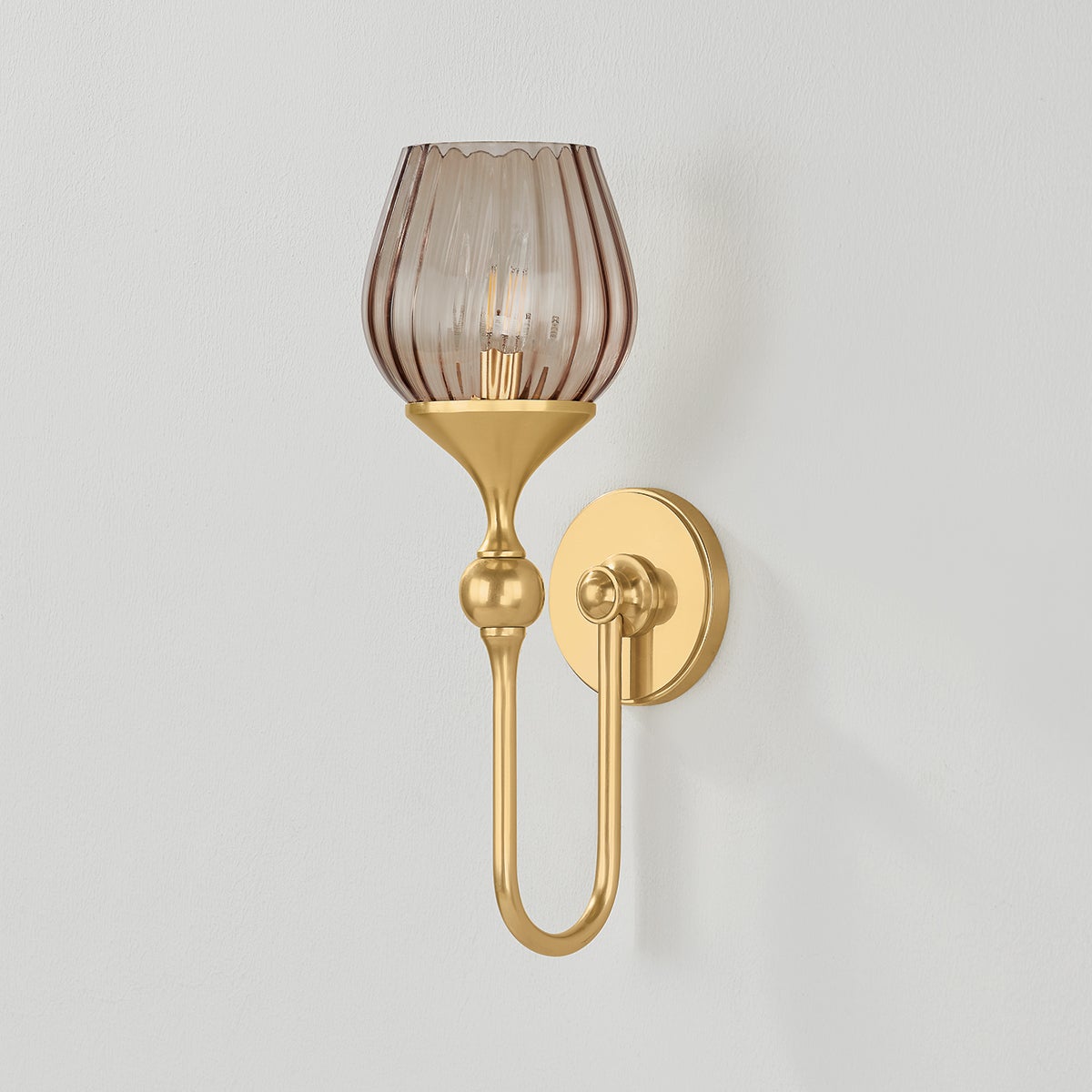 Chatton Wall Sconce in aged brass shown from a second angle to highlight the arm curve and shade silhouette.