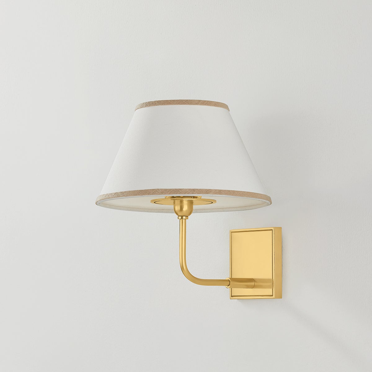 Durland Wall Sconce in aged brass shown from a second angle to highlight the arm curve and shade silhouette.