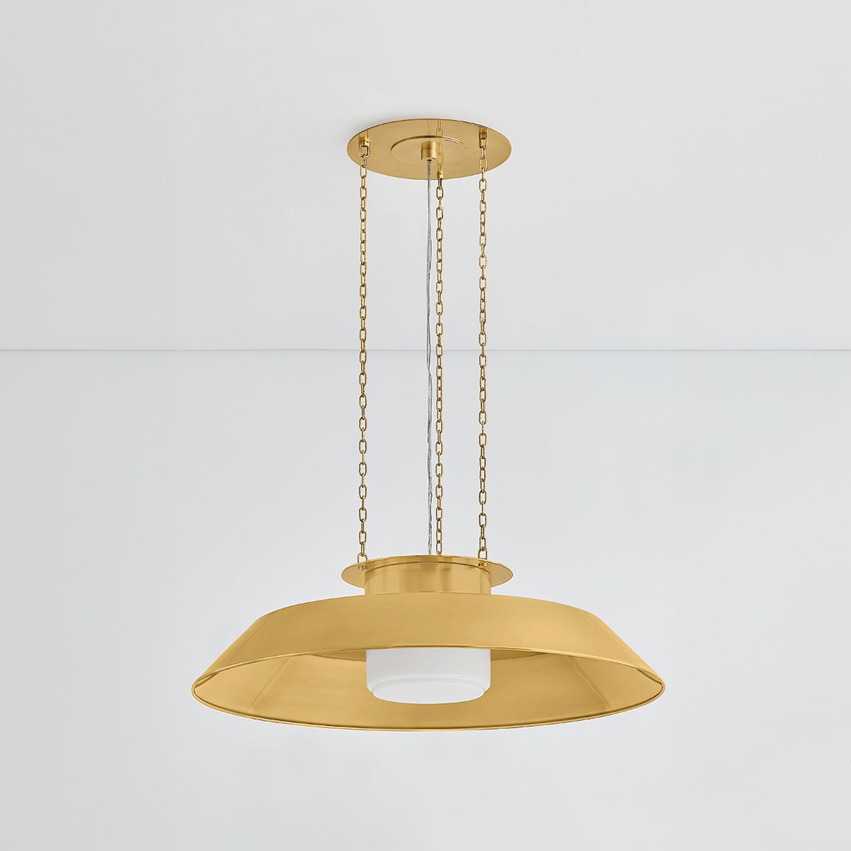 Woodrow Pendant 32" in aged brass shown from the front to reveal the shade shape and metal detail.