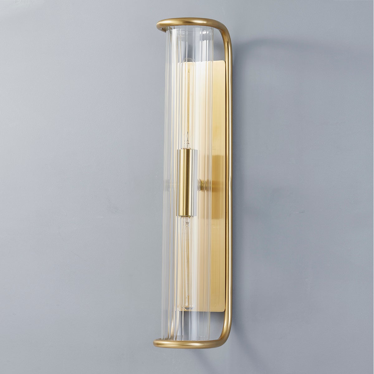 Fillmore Wall Sconce 5.5" x 26.25" in aged brass shown from a second angle to highlight the arm curve and shade silhouette.