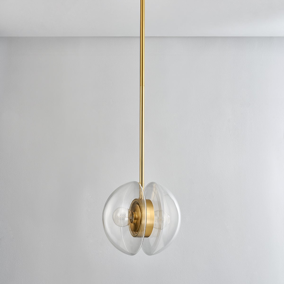 Kert Pendant 11.75" in aged brass shown from the front to reveal the shade shape and metal detail.