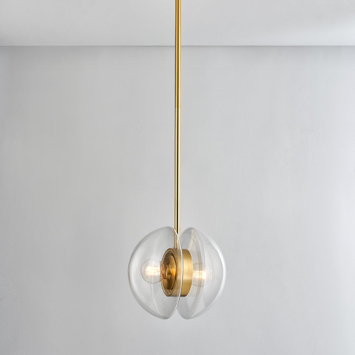 Close-up of the Kert Pendant 11.75" in aged brass showing the shade shape and metal detail.