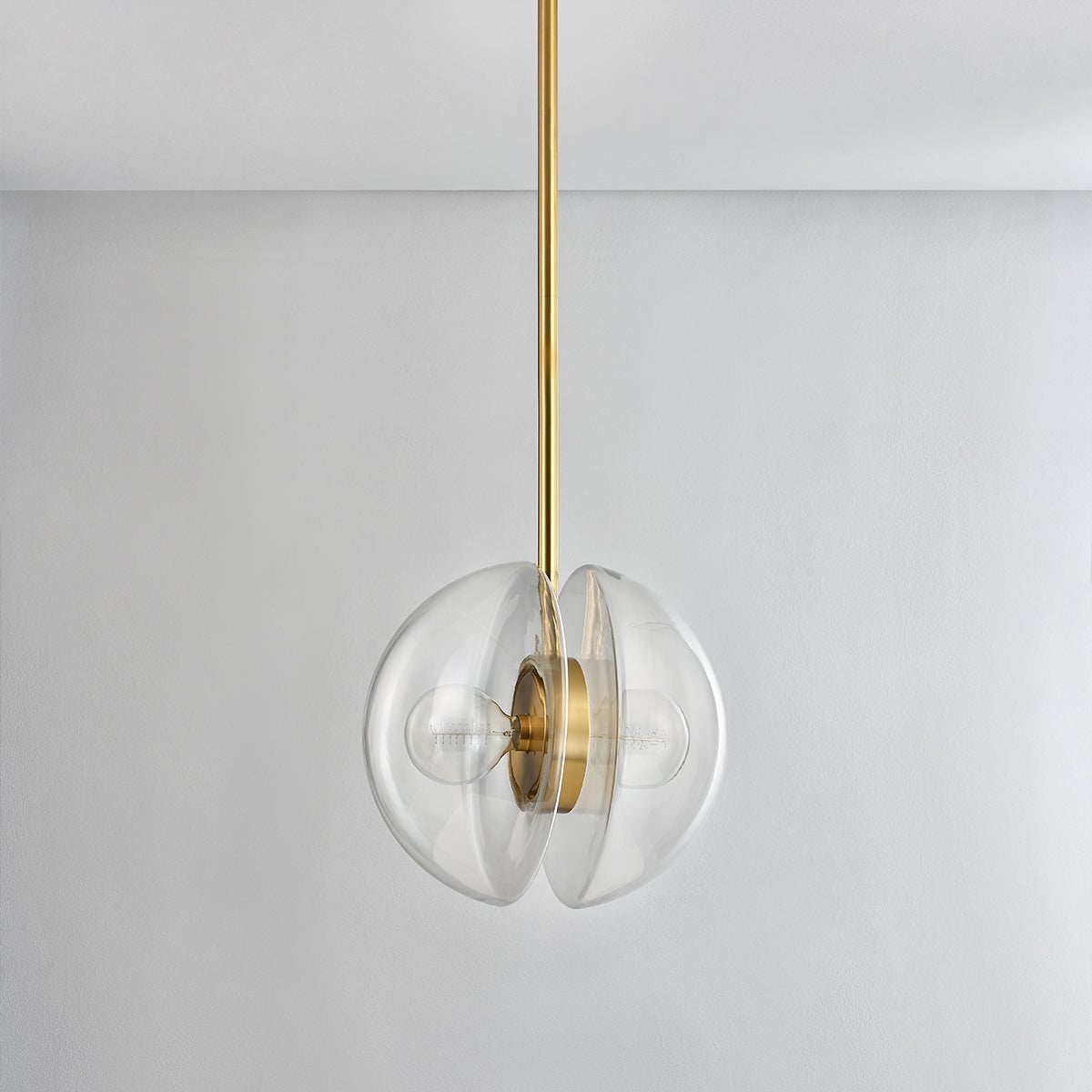 Kert Pendant 17" in aged brass shown from the front to reveal the shade shape and metal detail.