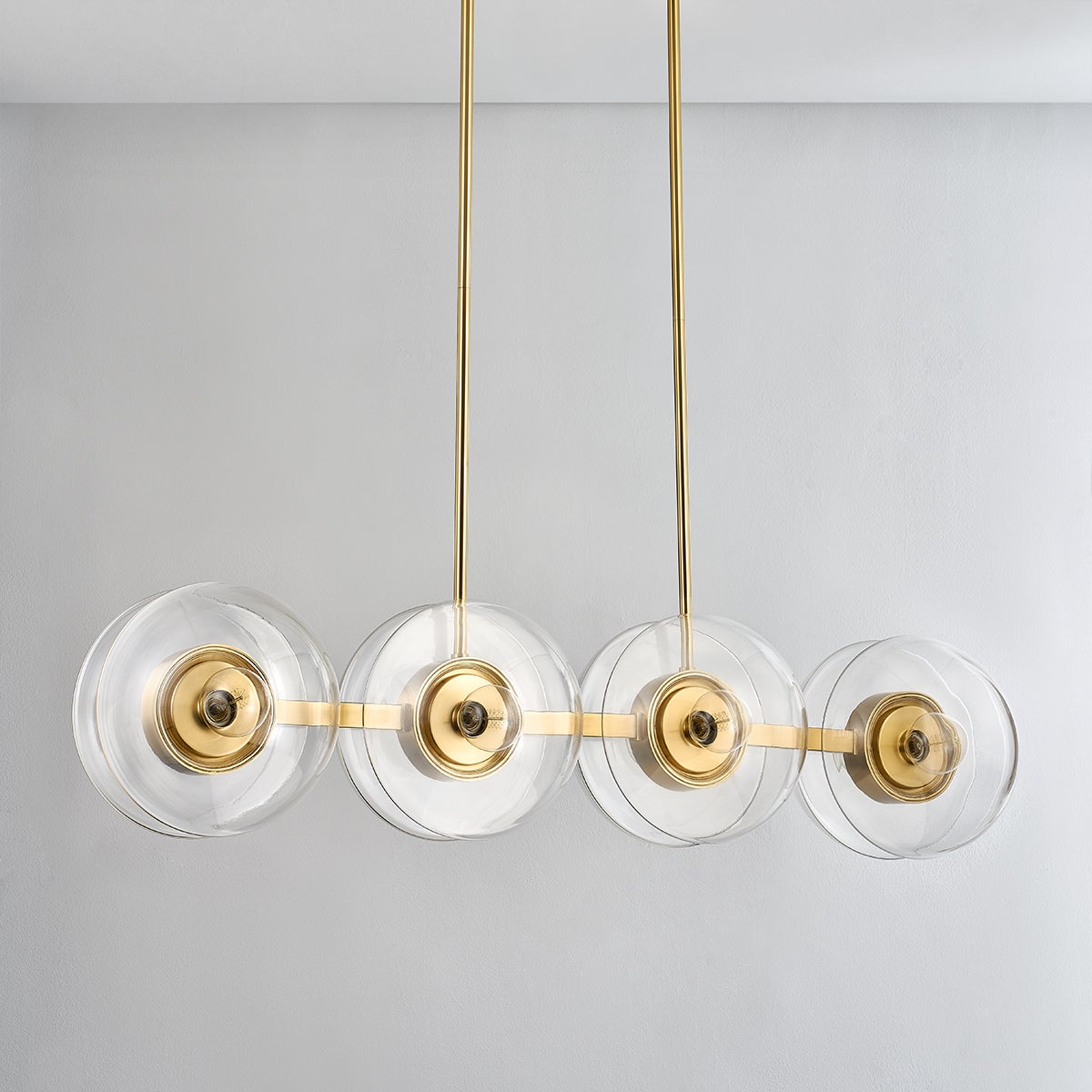 Kert Linear in aged brass shown from the front to reveal the extended frame and shade array.