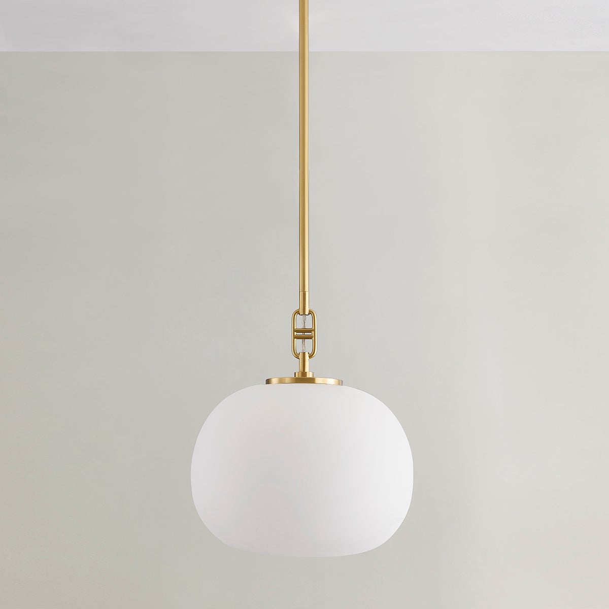 Ingels Pendant 11" in aged brass shown from a second angle to highlight the shade shape and metal detail.