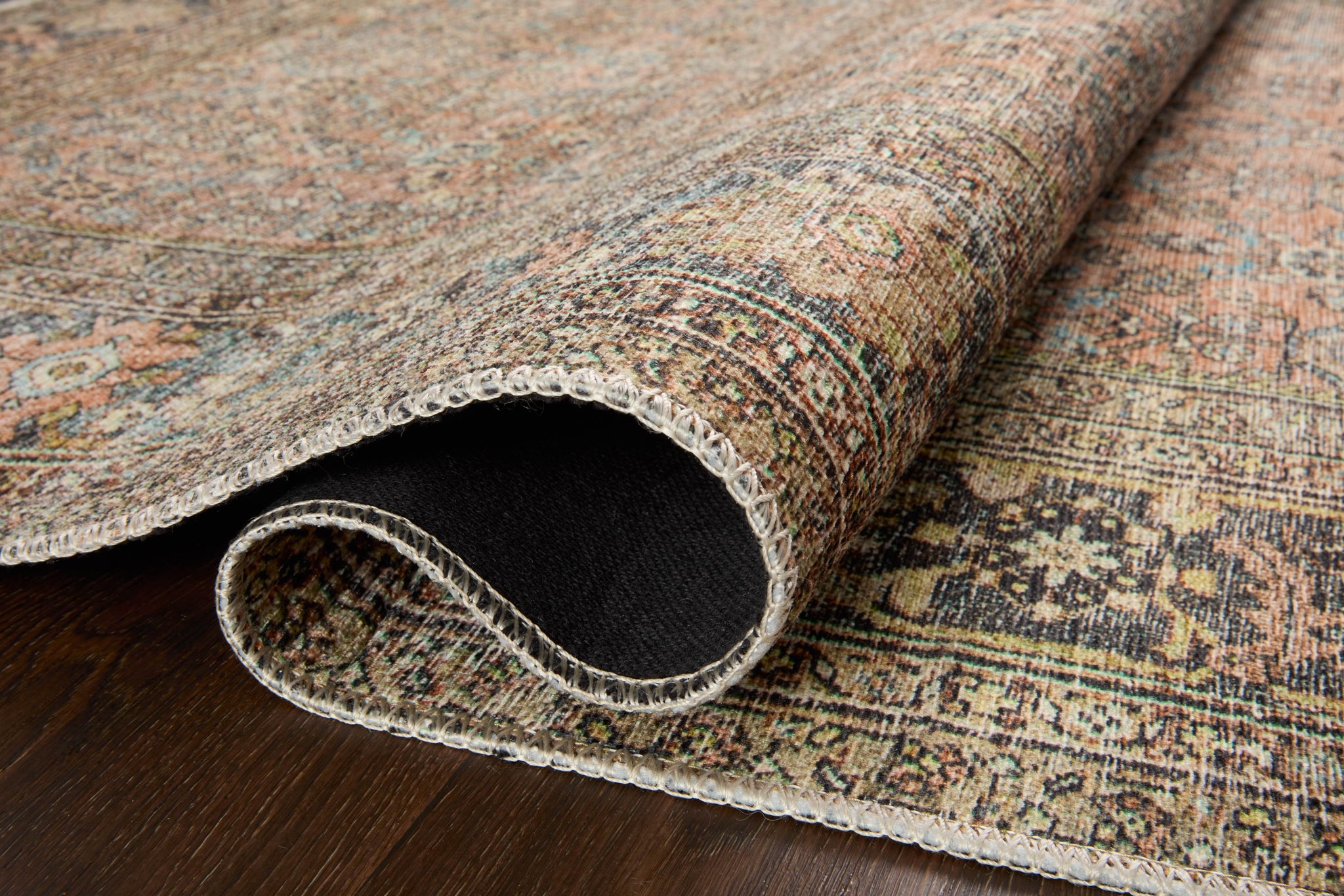 Adrian Terracotta / Multi styled underfoot in a layered living room at Laurie Yapp Home.