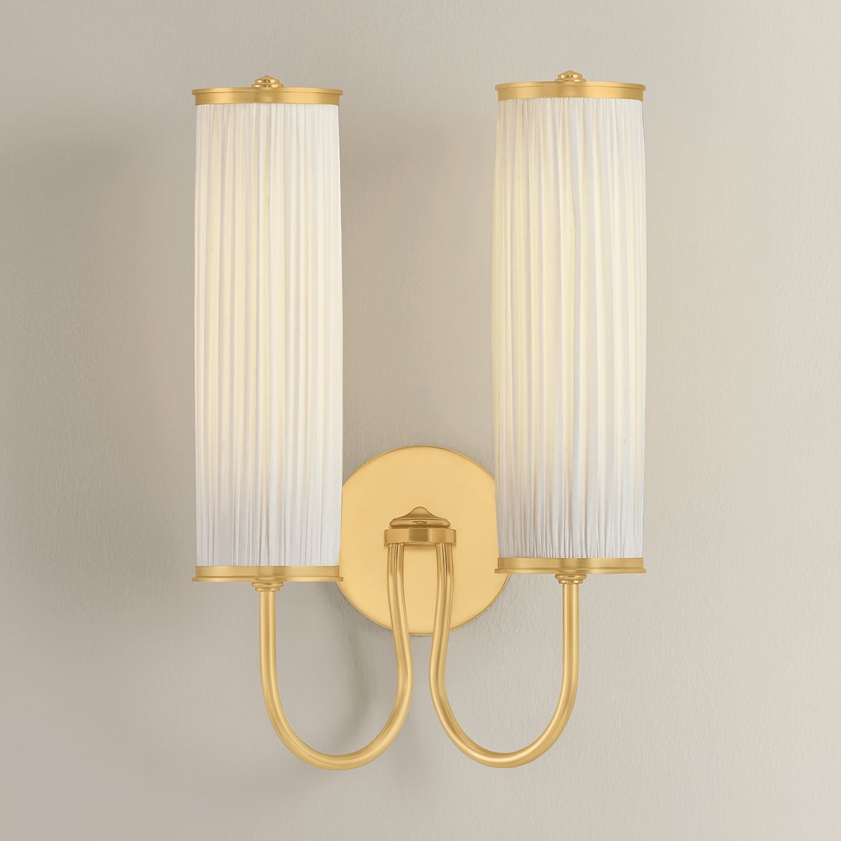 Elaine Wall Sconce in aged brass shown from the front to reveal the arm curve and shade silhouette.