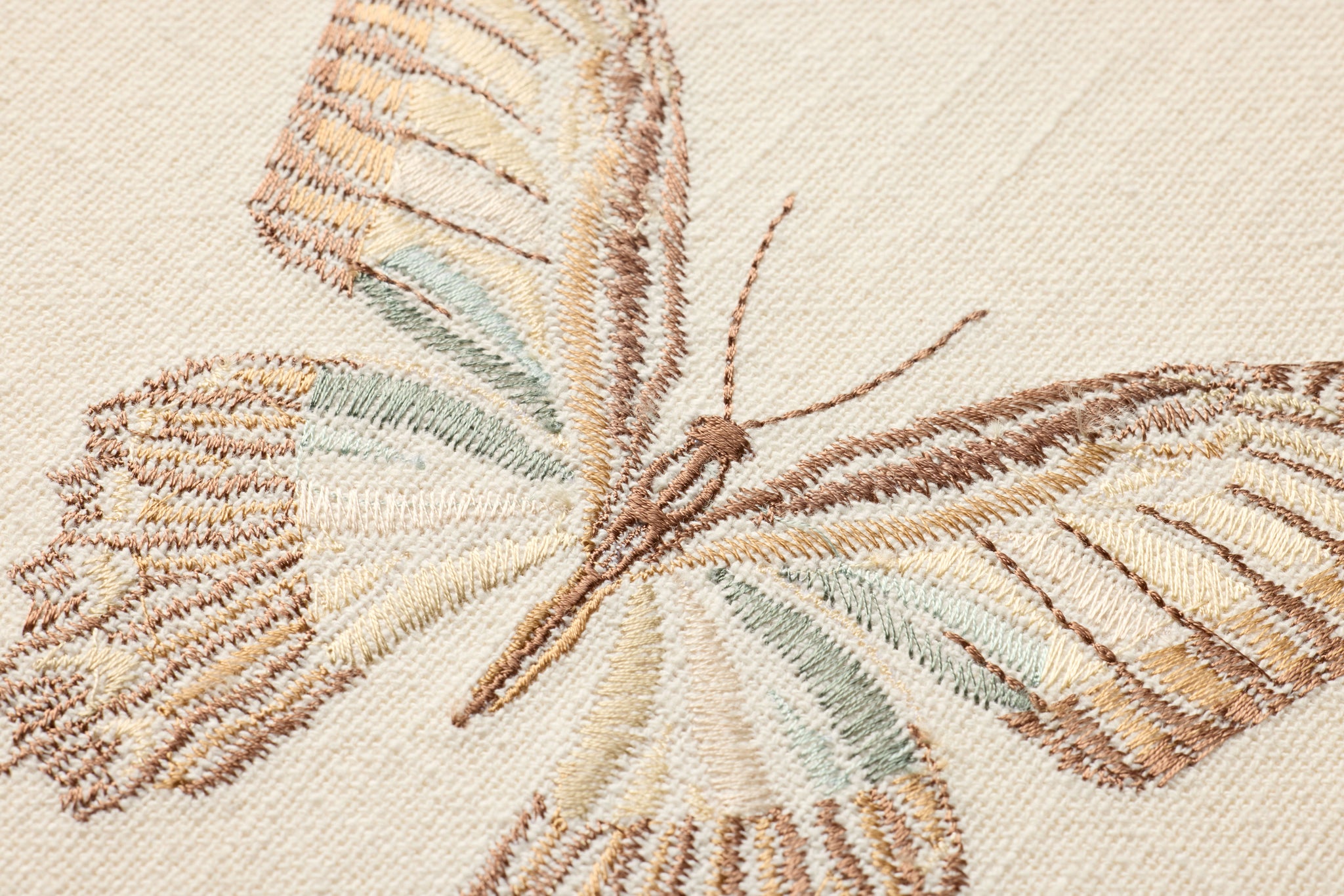 Butterfly Beige Ivory / Brown Rug Art shown from a different angle to reveal its pattern.