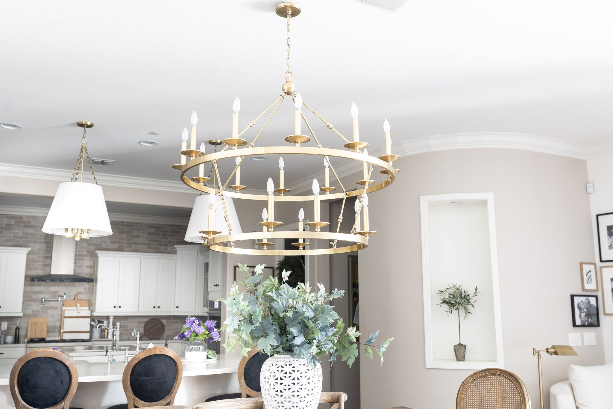 Allendale Chandelier 46.75" x 38" in aged brass styled in an elegant dining room for warm, layered light at Laurie Yapp Home.