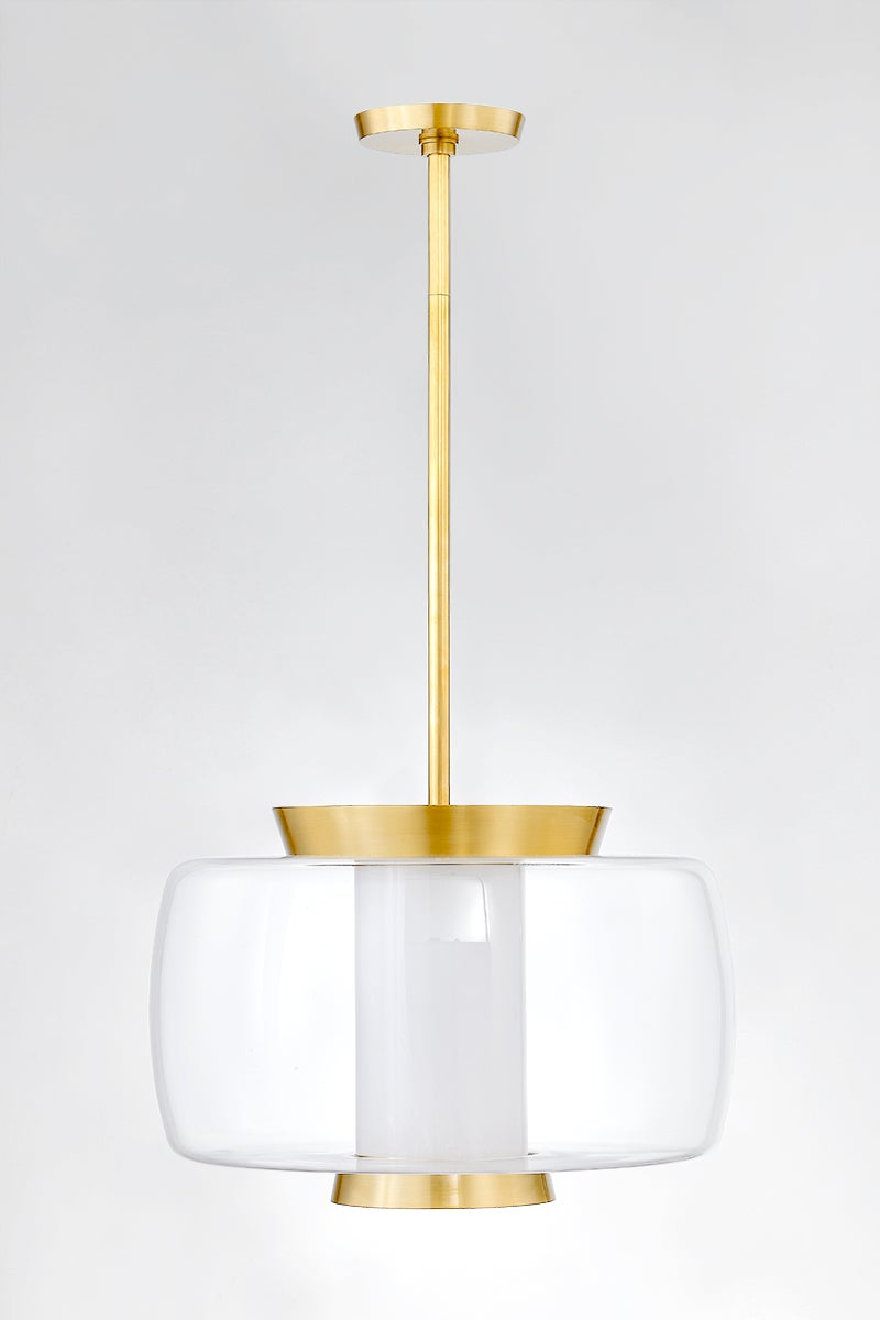 Beau Pendant 20" in aged brass shown from a second angle to highlight the shade shape and metal detail.