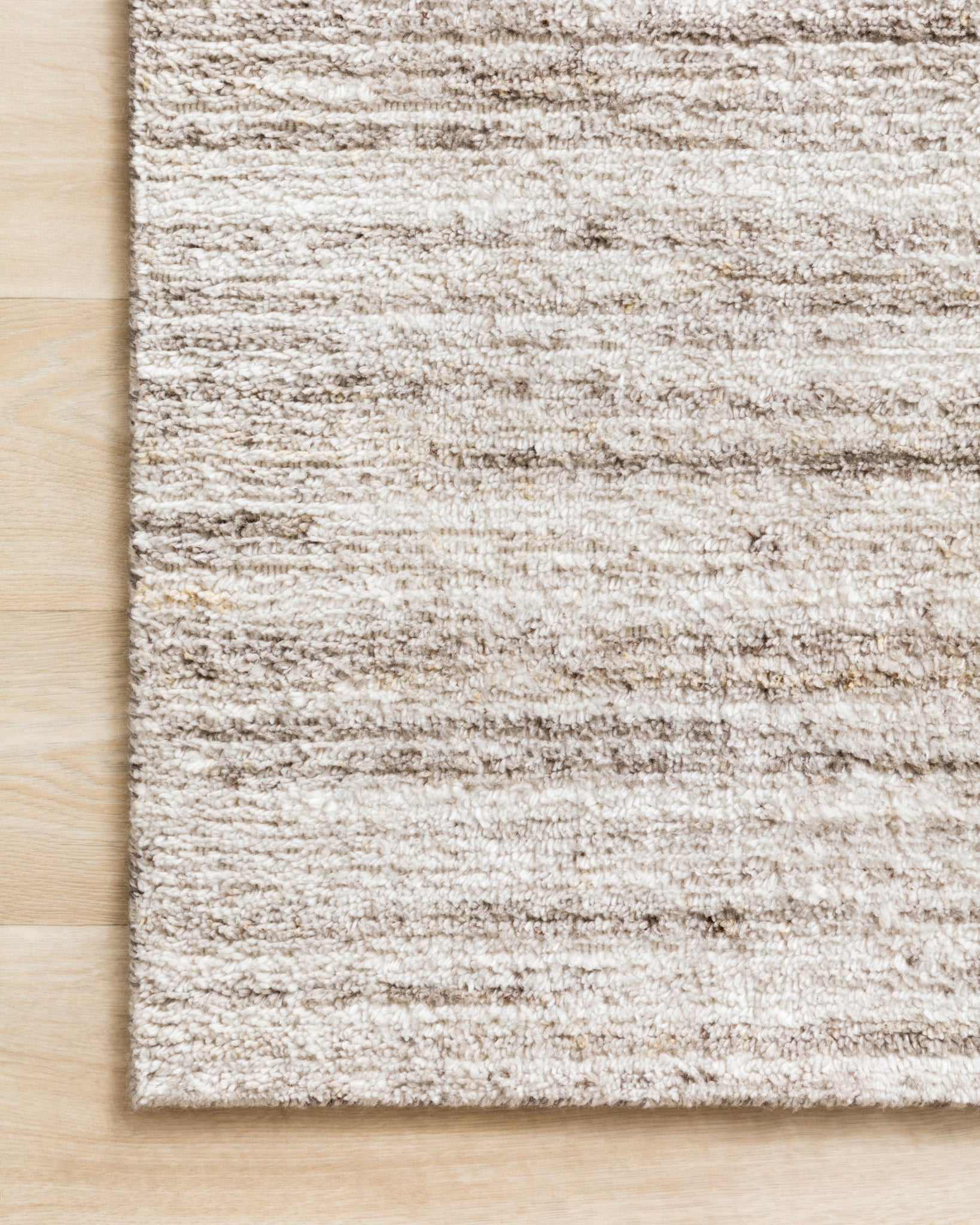 Side view of the Brandt Ivory / Oatmeal rug.