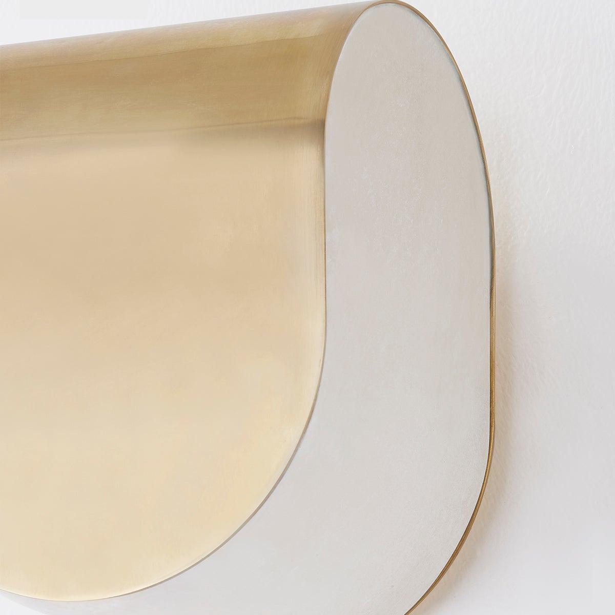 Close-up of the Briarwood Wall Sconce 6.5" in aged brass showing the arm curve and shade silhouette.