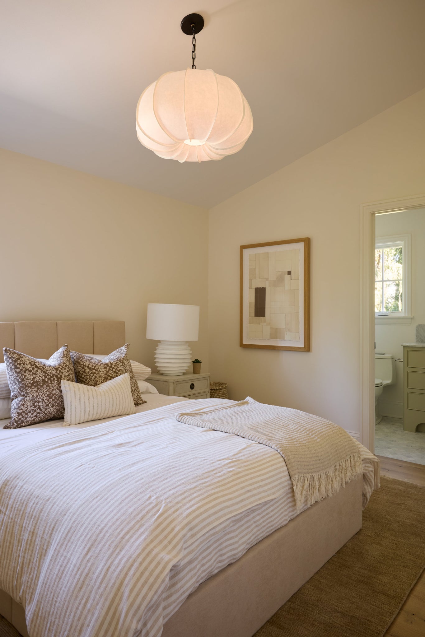 Bayu Pendant 26" styled in a welcoming entryway for warm, layered light at Laurie Yapp Home.