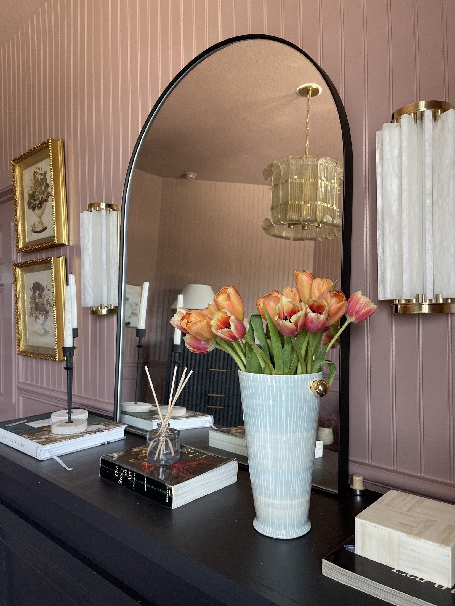 Hillside Wall Sconce 6" x 13.5" in aged brass styled in a modern bathroom for warm, layered light at Laurie Yapp Home.