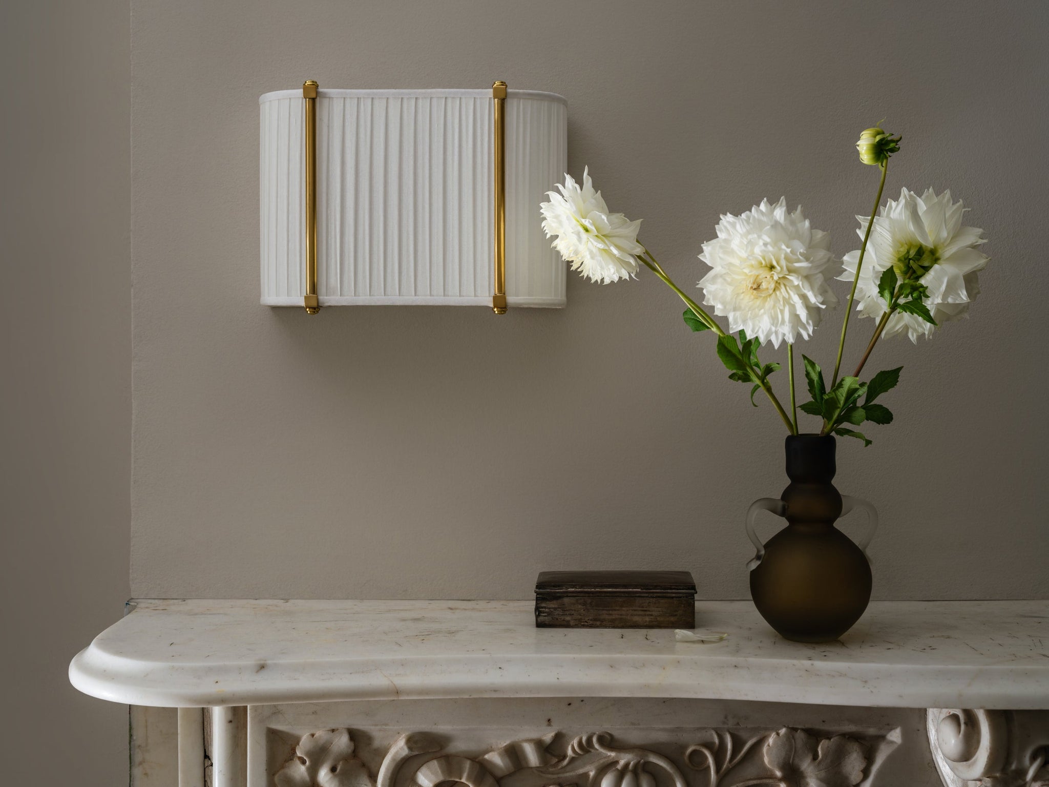 Cornell Wall Sconce 12" in aged brass styled in a modern bathroom for warm, layered light at Laurie Yapp Home.
