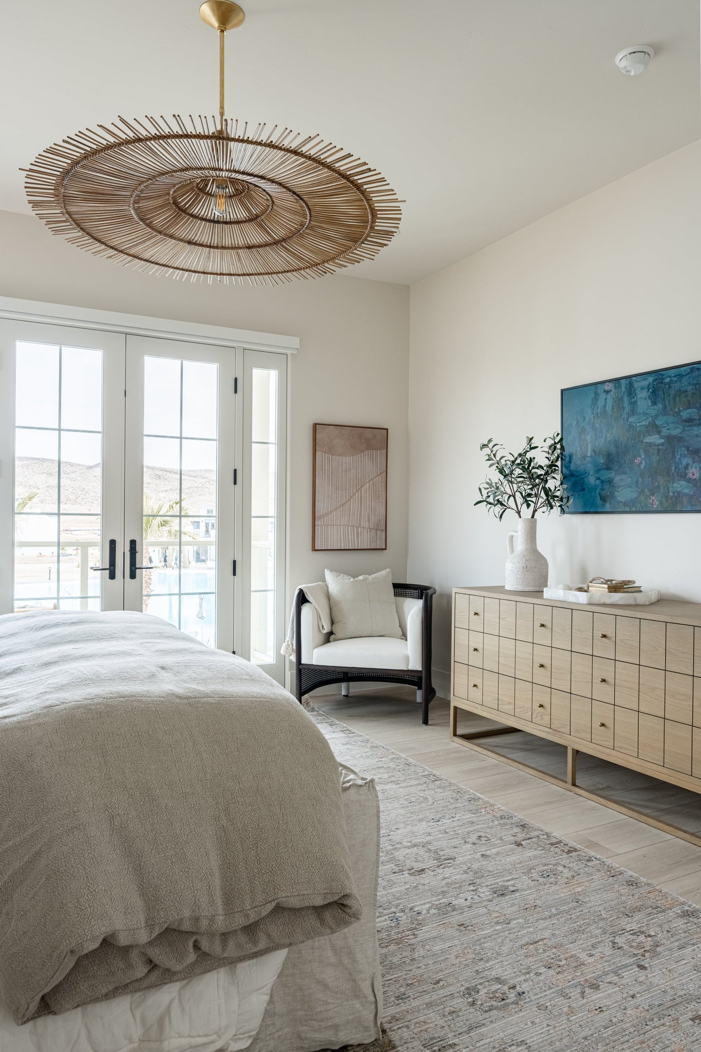 Costa Mesa Pendant 50" styled in an elegant dining room for warm, layered light at Laurie Yapp Home.