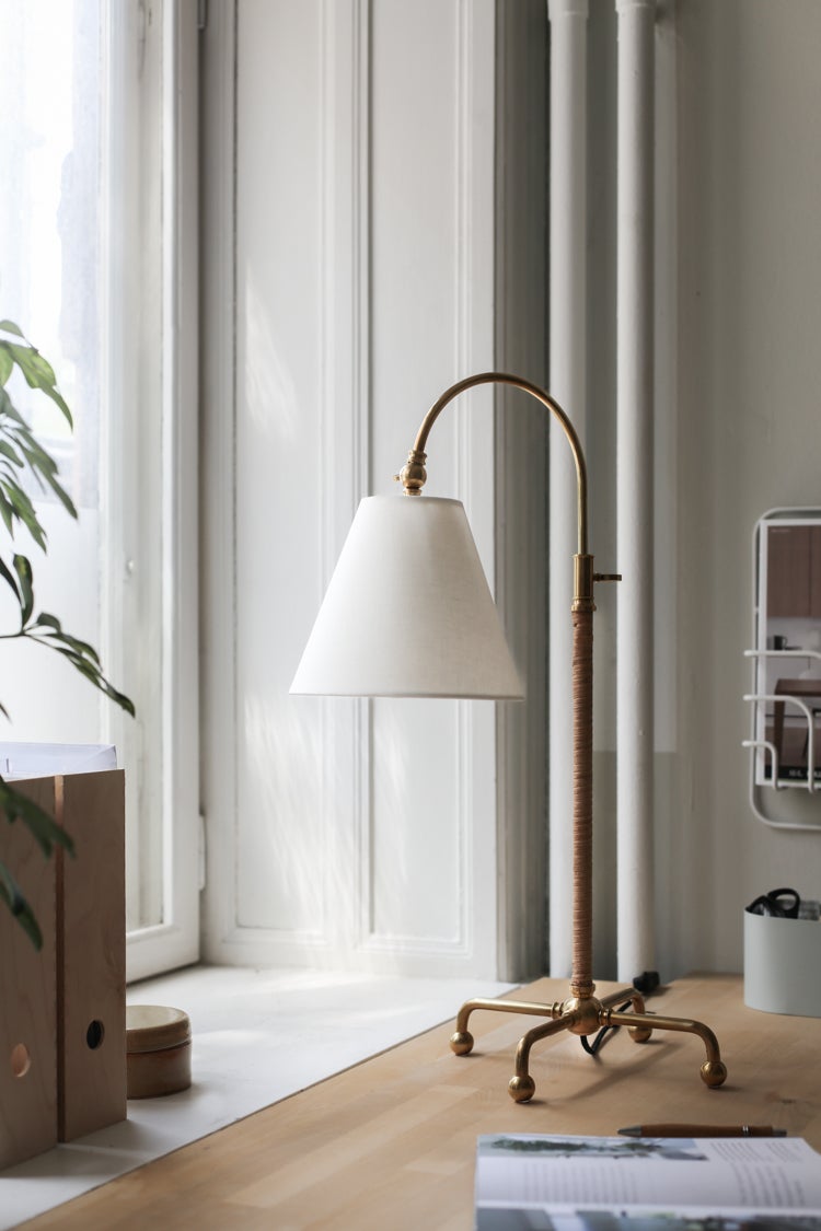 Curves No.1 Table Lamp in aged brass styled in a bedroom nightstand for warm, layered light at Laurie Yapp Home.