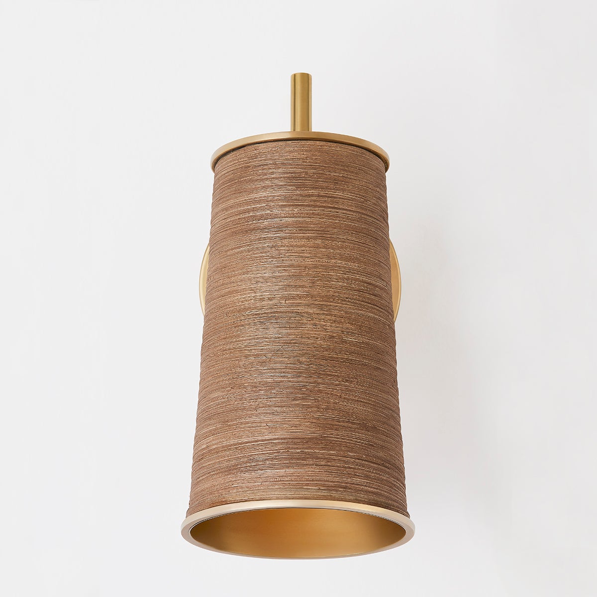 Delran Wall Sconce in aged brass shown from a second angle to highlight the arm curve and shade silhouette.