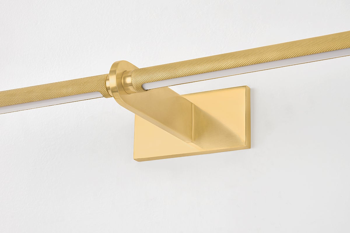 Close-up of the Deptford Picture Light 24" in aged brass showing the arm curve and shade proportion.
