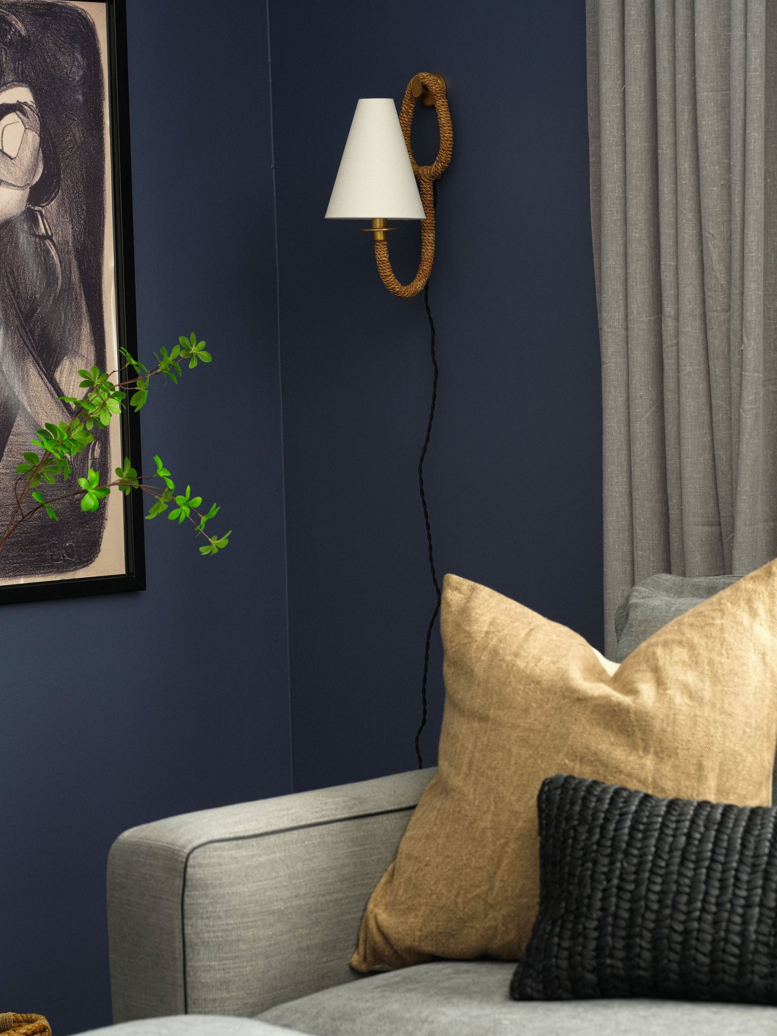 Deaver Plug-In Sconce styled in a bedroom for warm, layered light at Laurie Yapp Home.
