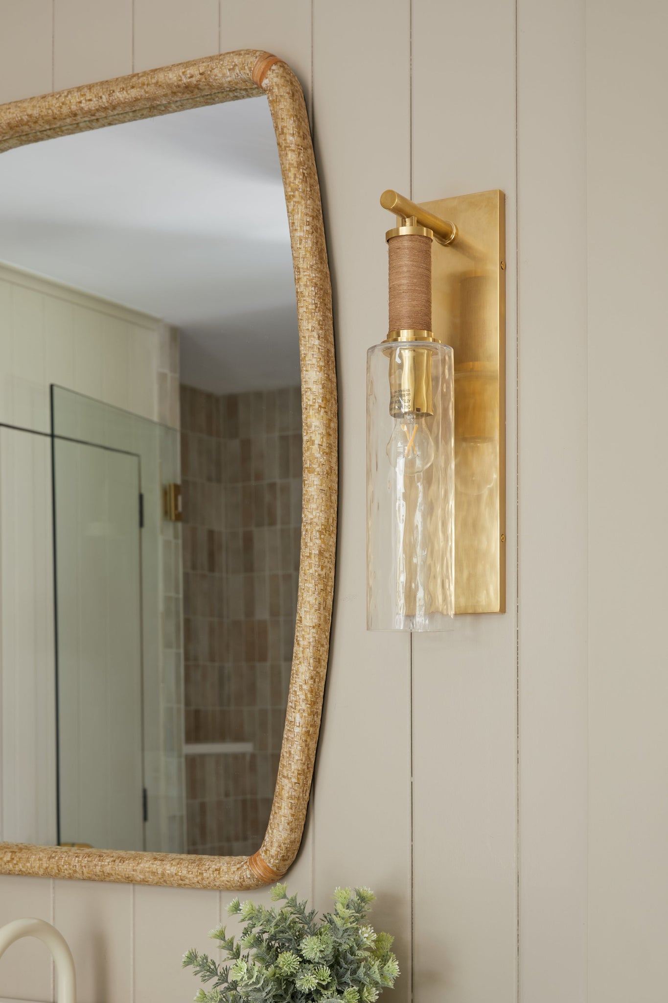 Eastchester Wall Sconce in aged brass styled in a curated living room for warm, layered light at Laurie Yapp Home.