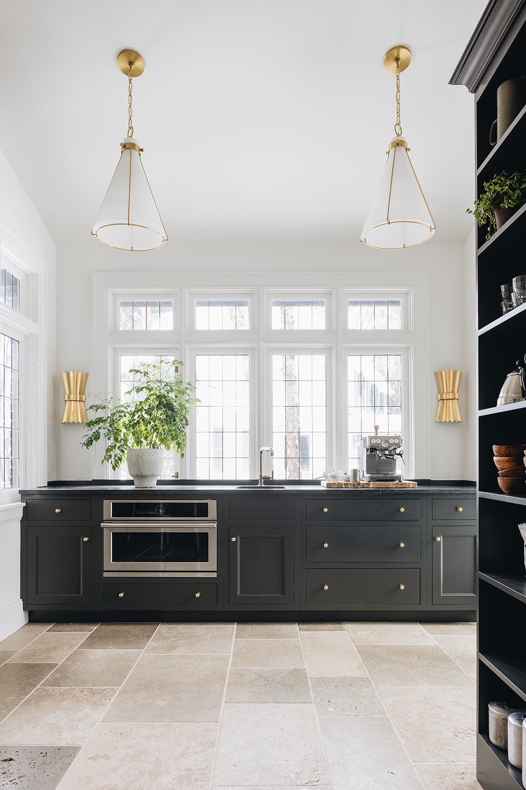 Eldridge Pendant 15.5" x 22" in aged brass styled in an elegant dining room for warm, layered light at Laurie Yapp Home.