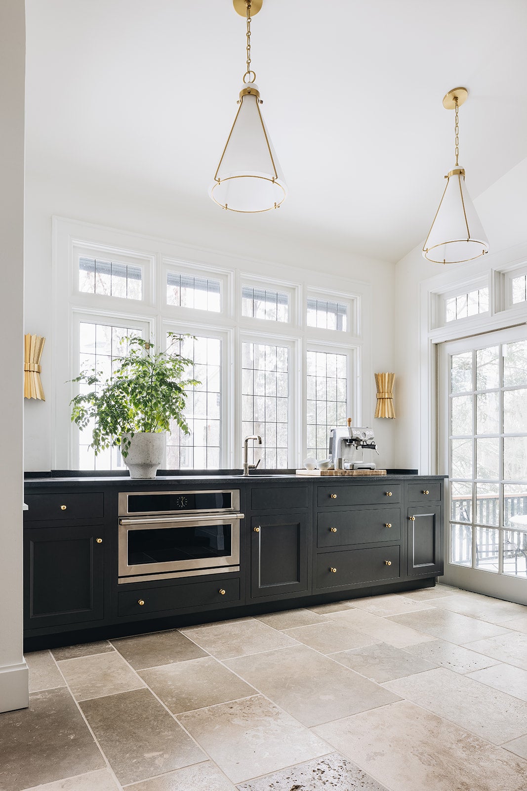 Eldridge Pendant 15.5" x 22" in aged brass styled in a bright kitchen for warm, layered light at Laurie Yapp Home.