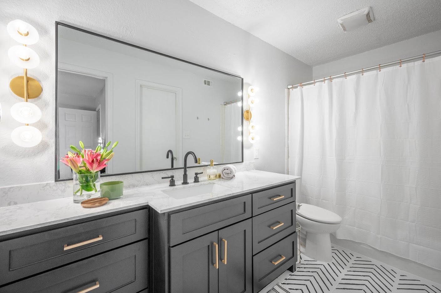 Close-up of the Elmont Bath And Vanity 4.75" x 24.75" in aged brass showing the arm spread and shade silhouette.