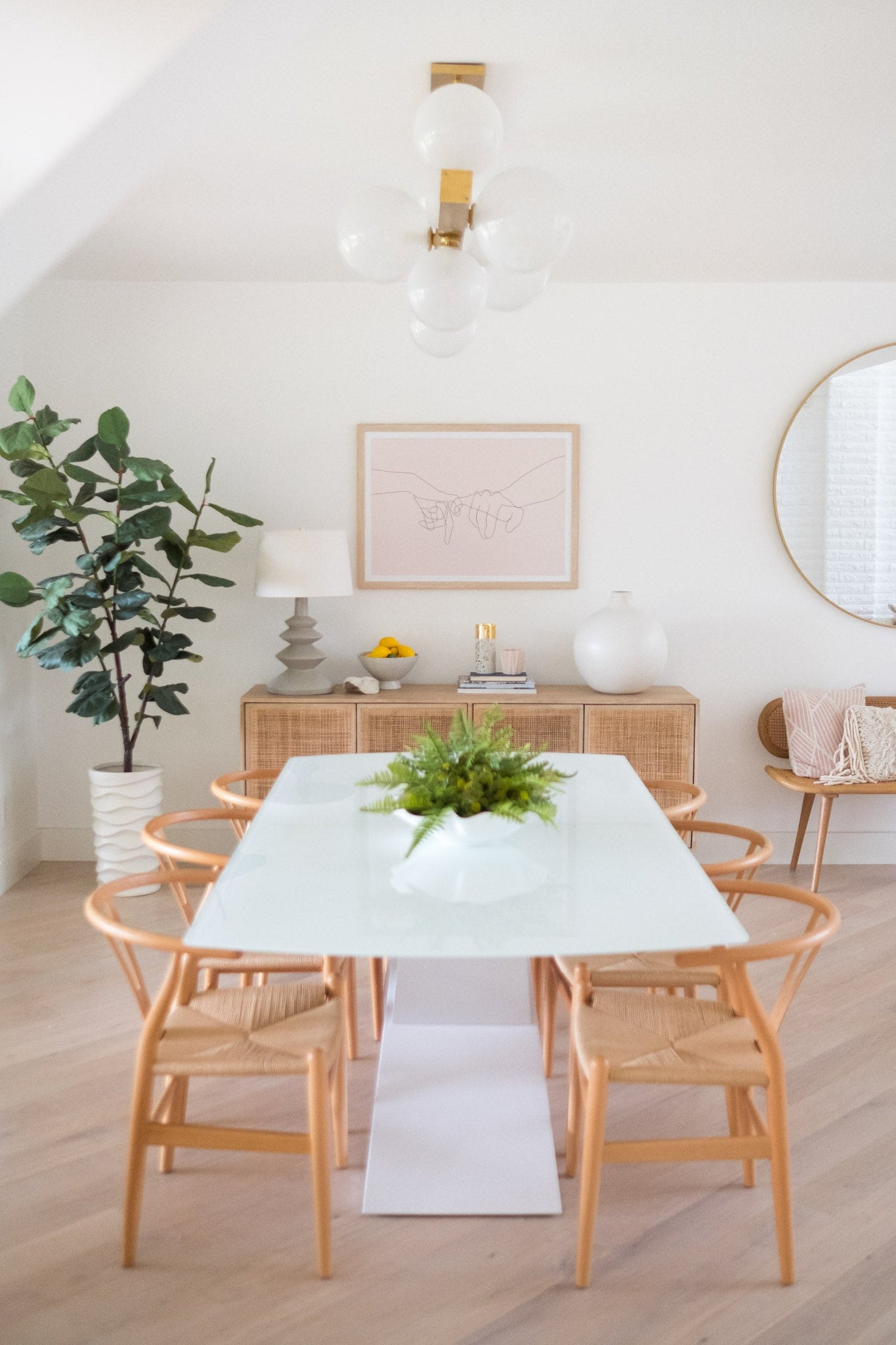 Hinsdale Linear in aged brass styled in a dining room for warm, layered light at Laurie Yapp Home.