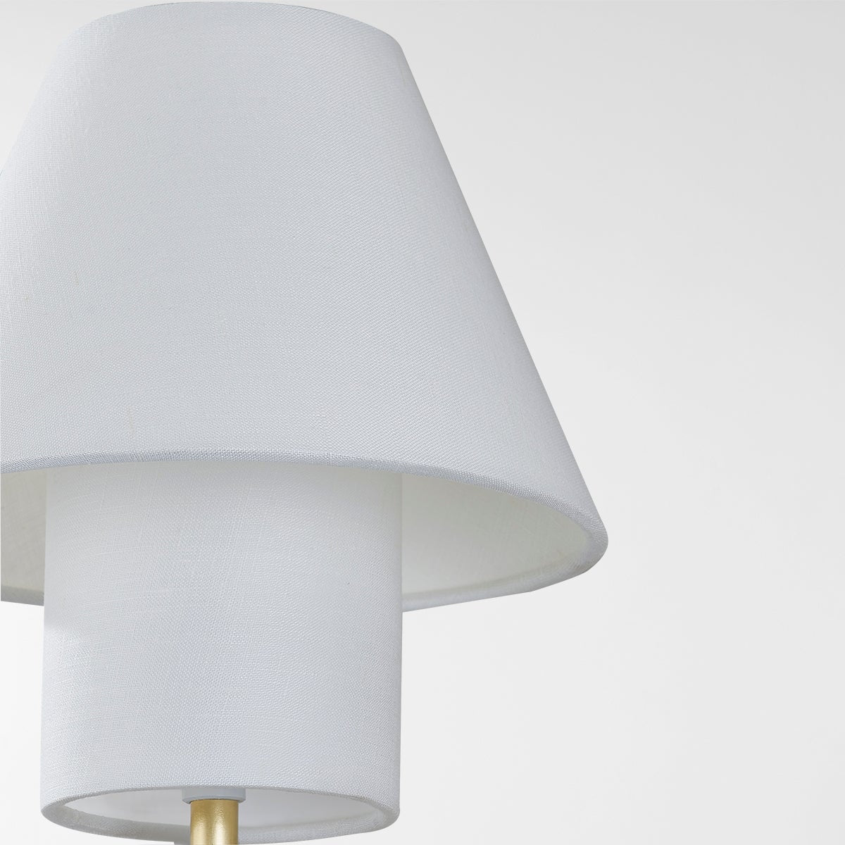 Close-up of the Glenmoore Wall Sconce in aged brass showing the arm curve and shade silhouette.