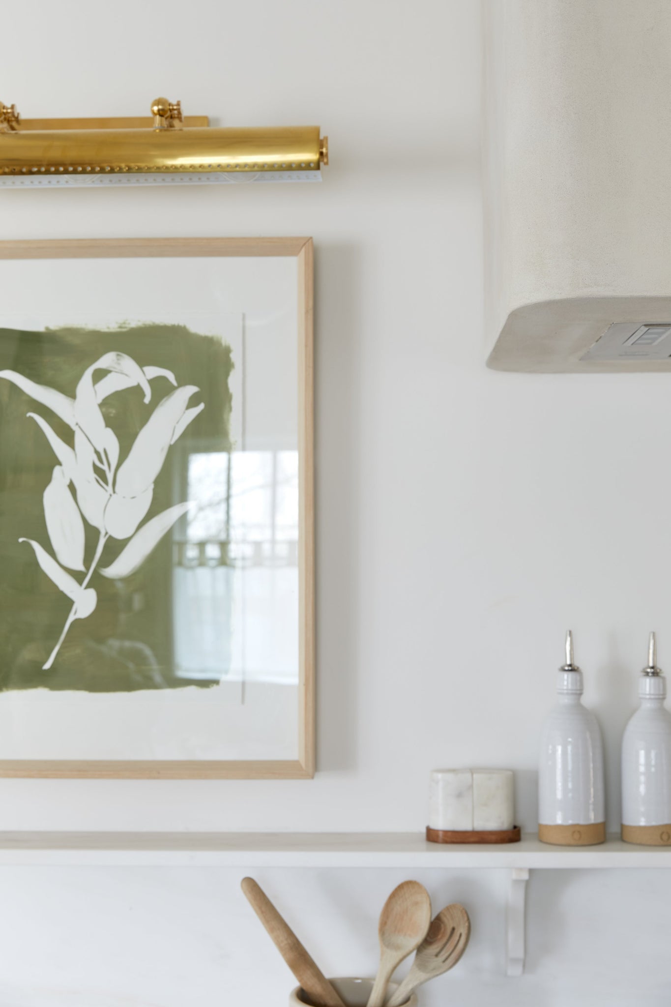 Hampshire Picture Light 23.25" in aged brass styled in a reading room for warm, layered light at Laurie Yapp Home.